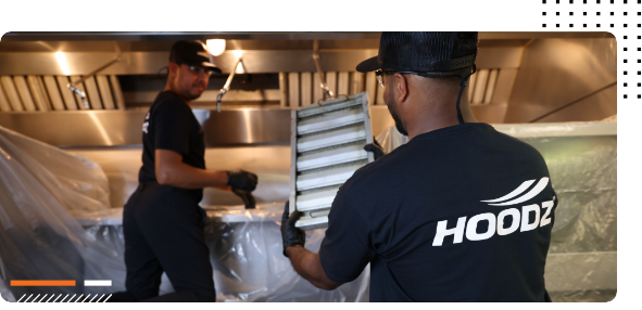 Technicians cleaning commercial Hood.