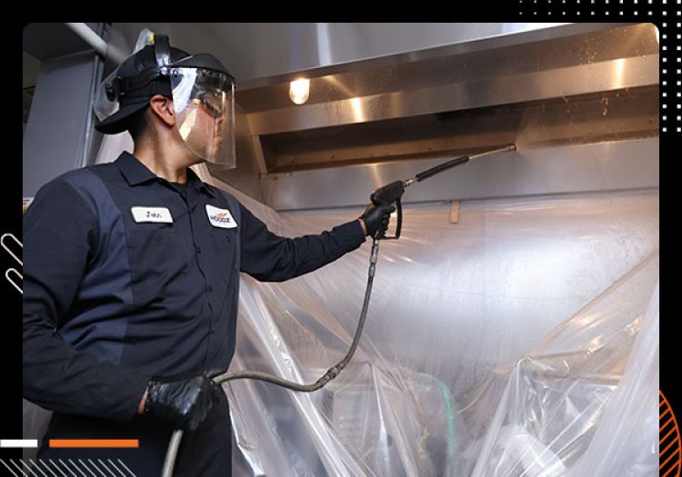 HOODZ worker cleaning exhaust hood